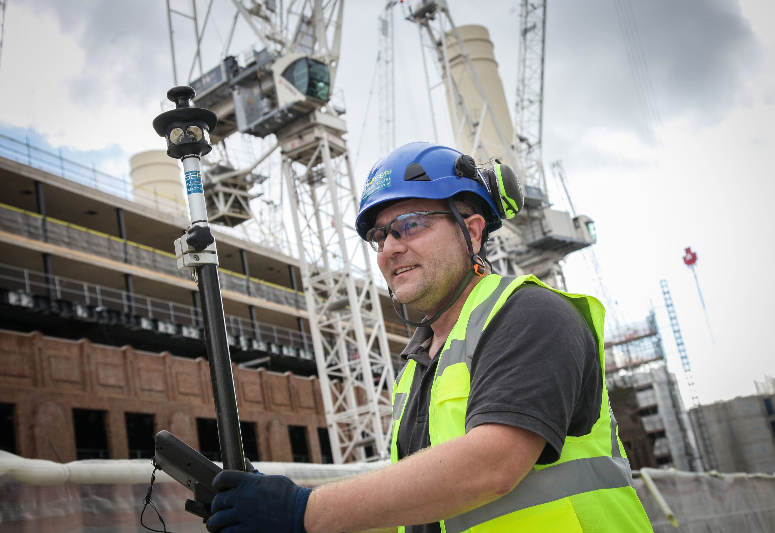 Setting out engineer working on site layout in Redbridge